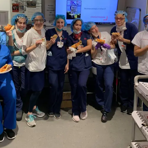 Health-care professionals at New York-Presbyterian Hospital enjoy kosher pizza delivered by Kosher19. Credit: Courtesy.