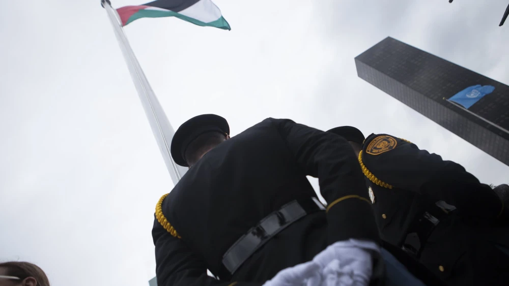 A Palestinian flag is raised at the United Nations headquarters in New York, Sept. 30, 2015. Photo by Amir Levy/Flash90.