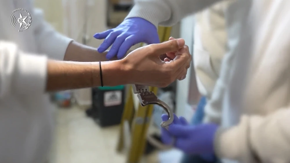 Suspect handcuffed by police