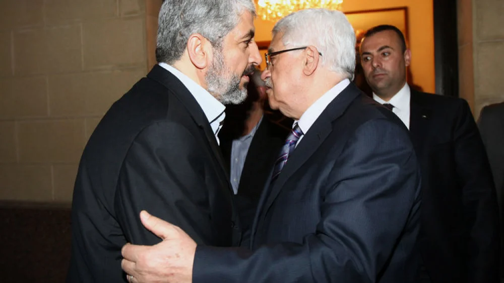 Hamas leader Khaleed Meshaal (left) meets with Palestinian Authority leader Mahmoud Abbas in Cairo, to implement the terms of a reconciliation deal they signed in the Egyptian capital in May 2011, which called for an interim government and general elections in a year, on Feb. 23, 2012. Photo by Mohammed al-Hums/Flash90.