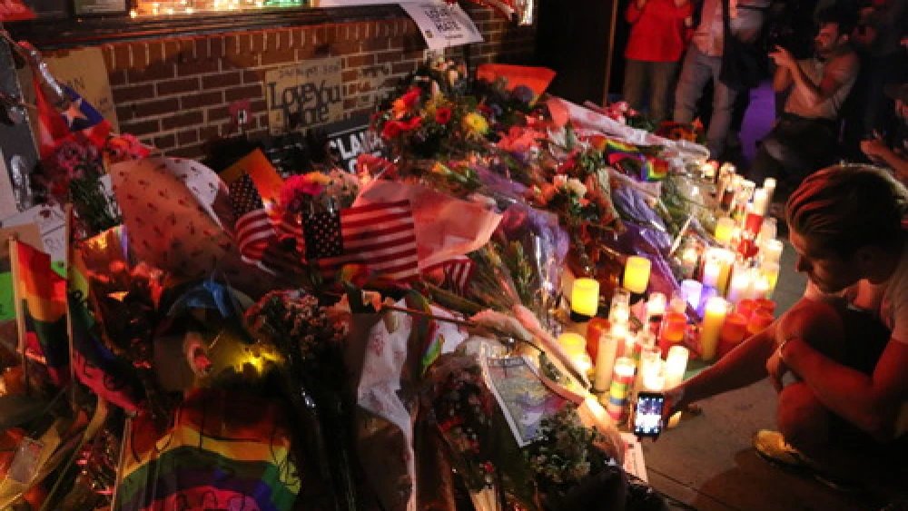 Click photo to download. Caption: A vigil for the victims of the Orlando nightclub shooting in New York City. Credit: Elisa S via Wikimedia Commons.