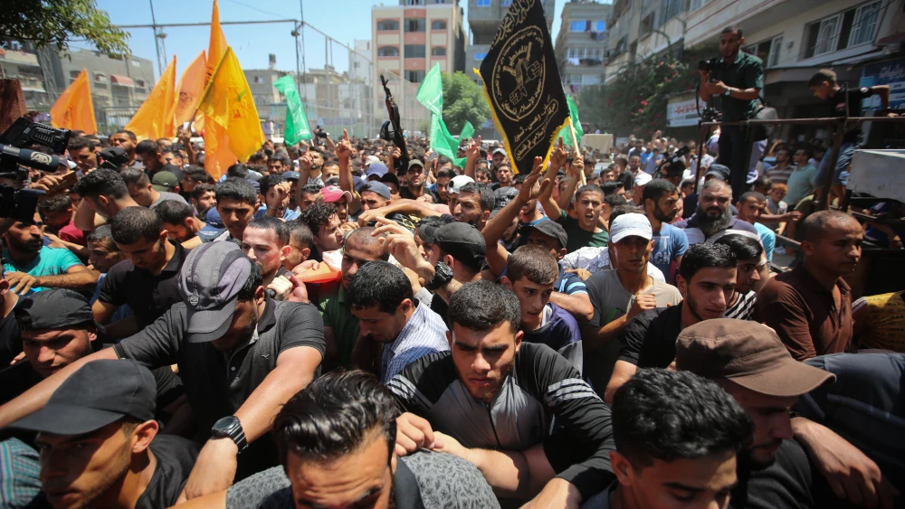 Mourners carry the body of Palestinian gunman Mohamad Al-Tramsi during his funeral in the Gaza Strip on Aug. 18, 2019. Al-Tramsi was killed along with two other Palestinians by IDF shelling in response to an infiltration attempt into Israel. Credit: Hassan Jedi/Flash90.