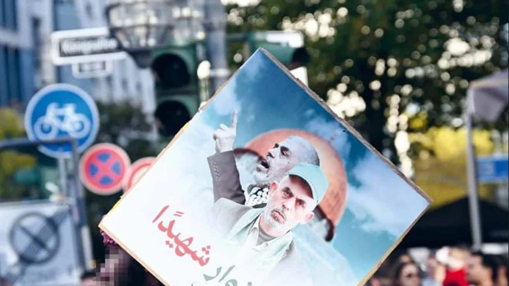 Protesters at an anti-Israel rally in Dusseldorf, Germany, hold up a poster celebrating slain Hamas senior leader Yahya Sinwar, October 2024. Credit: RIAS Berlin Commission.
