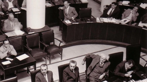 The Knesset plenum at Frumin House in Jerusalem in 1952. From bottom left to right: Haim-Moshe Shapira, Moshe Sharet, David Ben-Gurion and Ze’ev Sherf. Credit: Public Domain via Wikimedia Commons.