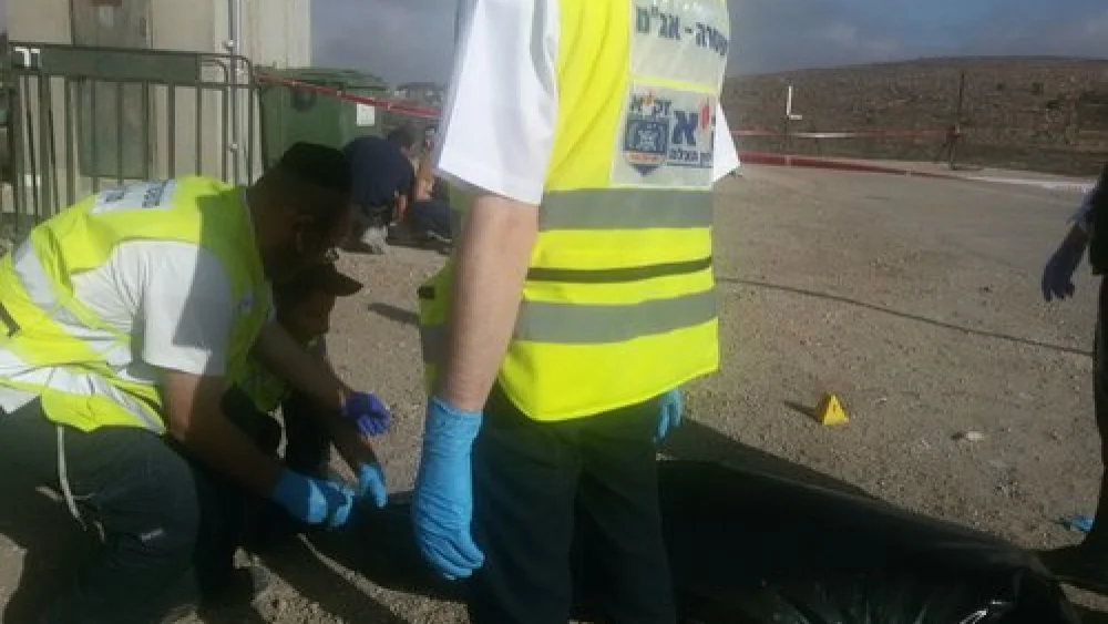 Volunteers from the ZAKA emergency response group collect remains at the scene of Tuesday's deadly Palestinian terror attack near Jerusalem. Credit: Courtesy ZAKA.
