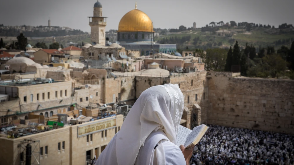 A man covers himself with a prayer shawl while praying near the Western Wall in Jerusalem's Old City, January 2019. Credit: Yonatan Sindel/Flash90.