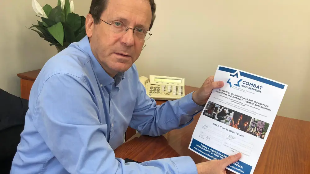 Jewish Agency chairman Isaac Herzog presents his signed pledge for Combat Anti-Semitism. Credit: Courtesy.