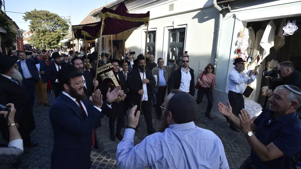 Rabbi Shlomo Koves (left) rejoices with the Budapest Jewish community as it celebrates two new Torah scrolls and synagogue openings in Hungary, on Sept. 22, 2019. Credit: Zsolt Demecs.