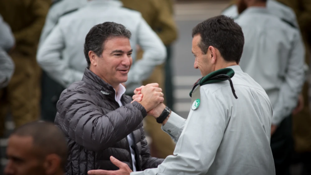 Director of the Mossad Yossi Cohen (left) greets outgoing Israel Defense Forces Chief of Intelligence Maj. Gen. Herzi Halevy at the Glilot military base near Tel Aviv, March 28, 2018. Photo by Miriam Alster/Flash90.