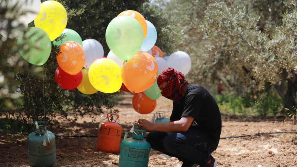 Palestinians in the Gaza Strip prepare explosive devices to be launched into Israel, on May 31, 2019. Photo by Hassan Jedi/Flash90.