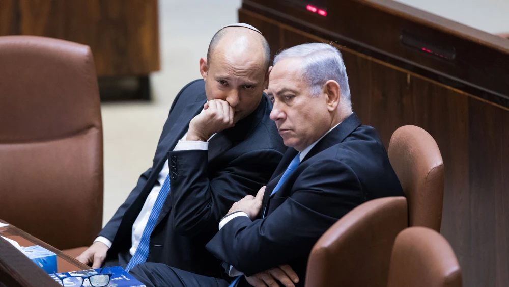 Israeli Prime Minister Benjamin Netanyahu speaks with then-Education Minister Naftali Bennett during a plenum session at the Knesset on Nov. 13, 2017. Photo by Yonatan Sindel/Flash90.