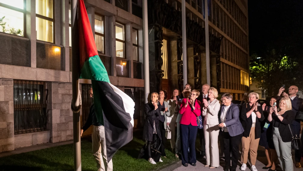 People hang a Palestinian flag in front of the Slovenian parliament building after the National Assembly recognized Palestinian statehood on June, 4, 2024 in Ljubljana, Slovenia. Photo credit: AFP via Getty Images.