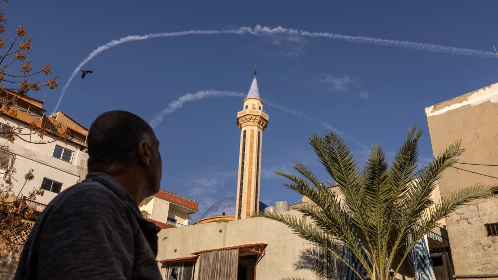 A Lebanese man watches contrails from IDF fighter jets in the sky over Tyre, Lebanon, on March 24, 2026. Photo by Fabio Bucciarelli/Middle East Images/AFP via Getty Images.