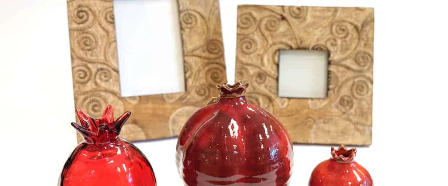 Glass pomegranates and hand-carved frames made in India. Credit: Dayenu.