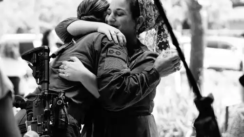 Hadassa Ben Ari (right), the head of "The Heroes of October 7th: Heroic Stories for Children" project, embraces a hero. Credit: Courtesy.