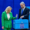 Likud Chairman Benjamin Netanyahu casts his ballot at a voting station in Jerusalem alongside his wife, Sara, on Nov. 1, 2022. Photo by Olivier FitoussiFlash90.