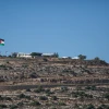 View of the Palestinian flag in the Palestinian city of Rawabi, as seen from the the Jewish community of Ateret, in the Binyamin District in Samaria, July 11, 2018. Photo by Hadas Parush/Flash90.