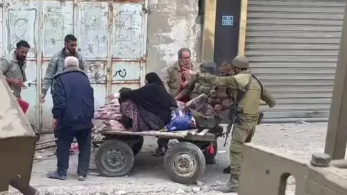 Israeli soldiers help an elderly Gazan woman, November 2023.
