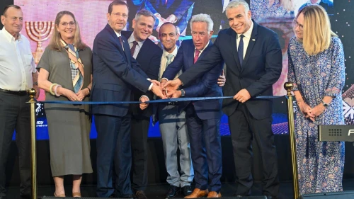 Israeli-Canadian businessman Sylvan Adams (third from right) cuts the ribbon to inaugurate the Sylvan Adams Emergency Hospital along with Israeli Prime Minister Yair Lapid (second from right) and Israeli President Isaac Herzog (third from left), together with other dignitaries, July 28, 2022. Credit: Jenny Yerushalmi.