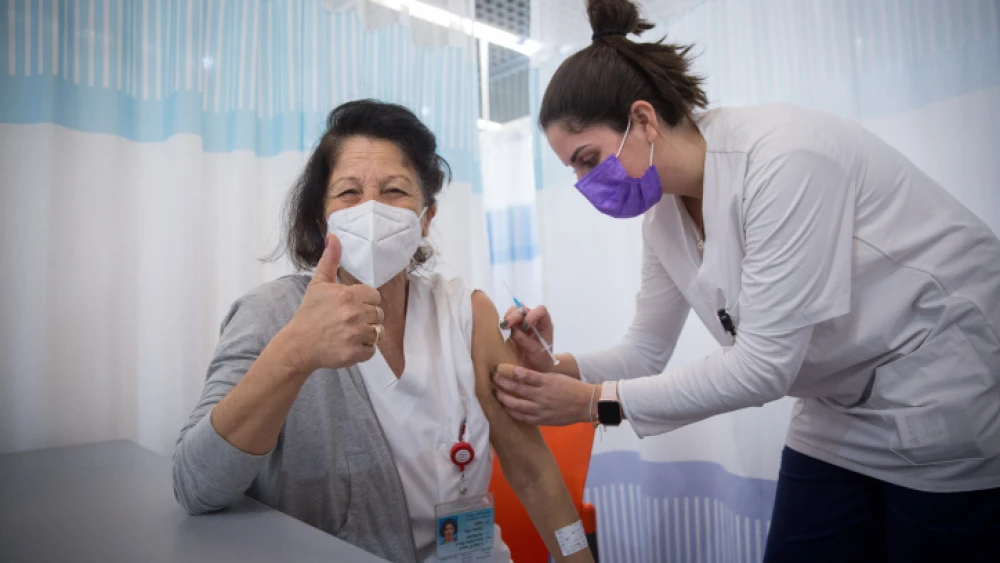 A staff member receives a second dose of Pfizer's BioNTech COVID-19 vaccine at the Sheba Medical Center at Tel HaShomer on Jan. 10, 2021. Photo by Miriam Alster/Flash90.