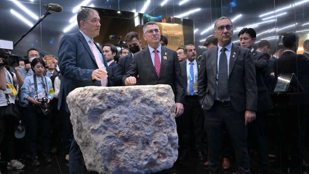 Israeli Foreign Minister Gideon Sa'ar (center) stands behind a stone on display that was part of a fortified tower built by the Hasmoneans in Jerusalem over 2,000 years ago, at the Israel Pavilion at Expo 2025 in Osaka, Japan, May 15, 2025. Photo by Shlomi Amsalem/MFA.
