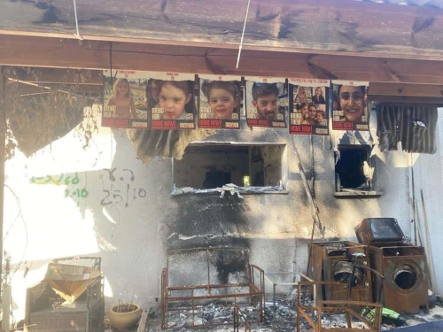 Posters of Sharon Aloni-Cunio, David Cunio, their twin daughters Emma and Yuli, and Sharon's niece Emilia Aloni near their home in Nir Oz, Jan. 16, 2024. Photo by Amelie Botbol.