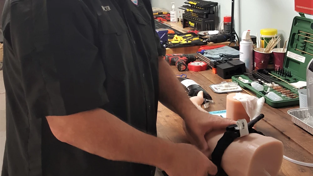 Chiam Naiditch, the founder and president of Magen Chicago, demonstrates how to apply a tourniquet. Photo by Bradley Martin.