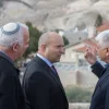 Jewish Home Party leader Naftali Bennett (center) speaks with Ma’ale Adumim Mayor Benny Kasriel (right) before the start of a special Jewish Home faction meeting on Jan. 2, 2018. Bennett has advocated for a Knesset bill to be introduced after president-elect Donald Trump takes office on Jan. 20 calling, for Israel’s annexation of Ma’ale Adumim. Credit: Yonatan Sindel/Flash90.