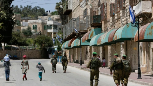Israeli soldiers seen patrolling on Shuhada Street in Hebron, April 16, 2014. Photo by Miriam Alster/Flash90.