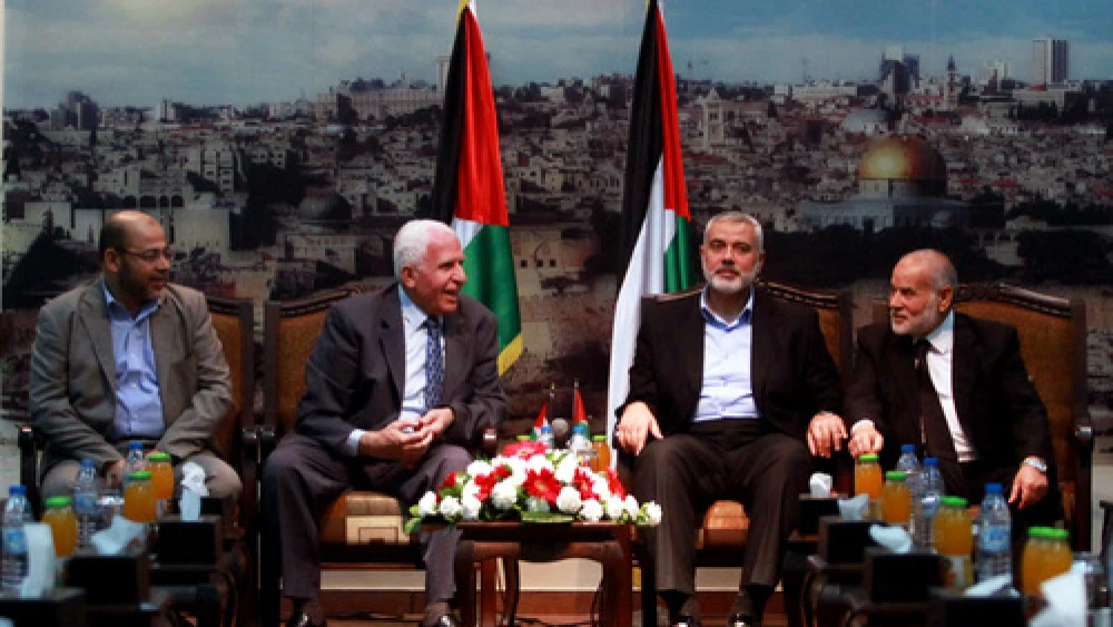 From left: Senior Hamas leader Moussa Abu Marzouk, senior Fatah official Azzam al-Ahmed, head of the Hamas government Ismail Haniyeh and deputy speaker of the Gaza-based Palestinian Parliament Ahmed Bahar attend a meting in Gaza City on April 22, 2014. Credit: Abed Rahim Khatib/Flash90.