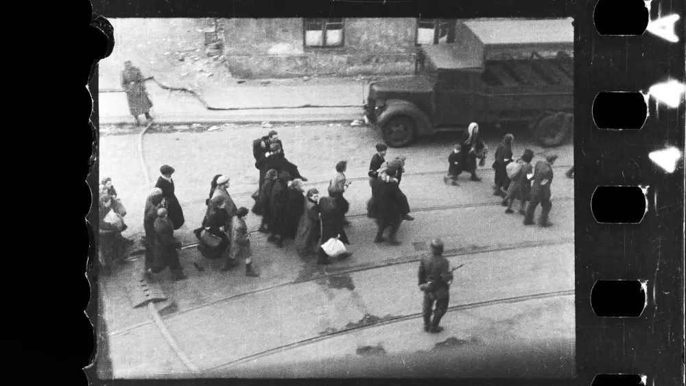 Jews in the process of being deported from the Warsaw Ghetto following the revolt of April-May 1943. From the family archives of Maciej Grzywaczewski, son of Leszek Grzywaczewski. Photo by Zbigniew Leszek Grzywaczewski. Credit: POLIN Museum.
