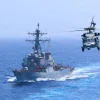 USS Donald Cook (DDG 75) transits the Arabian Sea while an MH-60S Sea Hawk flies nearby. Credit: United States Central Command.