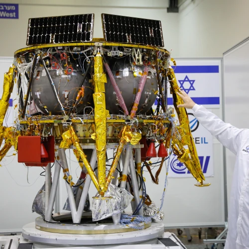 Ofer Doron, head of IAI's MBT Space Division speaks near the Israeli spacecraft of the SpaceIL team's spacecraft, during a press conference at the Israel Aerospace facility in Yahud on July 10, 2018. Photo by Flash90.