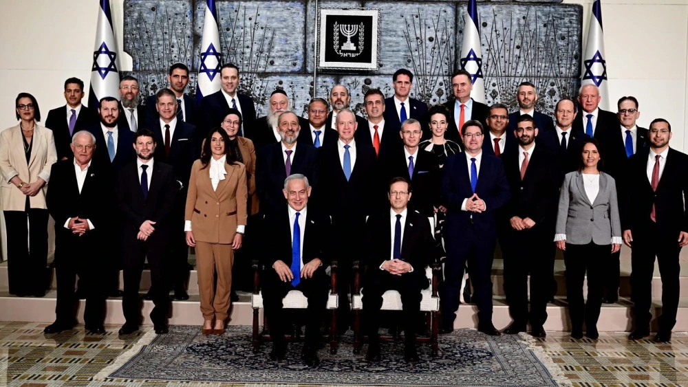 Israeli President Isaac Herzog and Israeli Prime Minister Benjamin Netanyahu sit at the center of the traditional photograph of the incoming government at the President's Residence in Jerusalem, Dec. 29, 2022. Credit: Avi Ohayon/GPO.