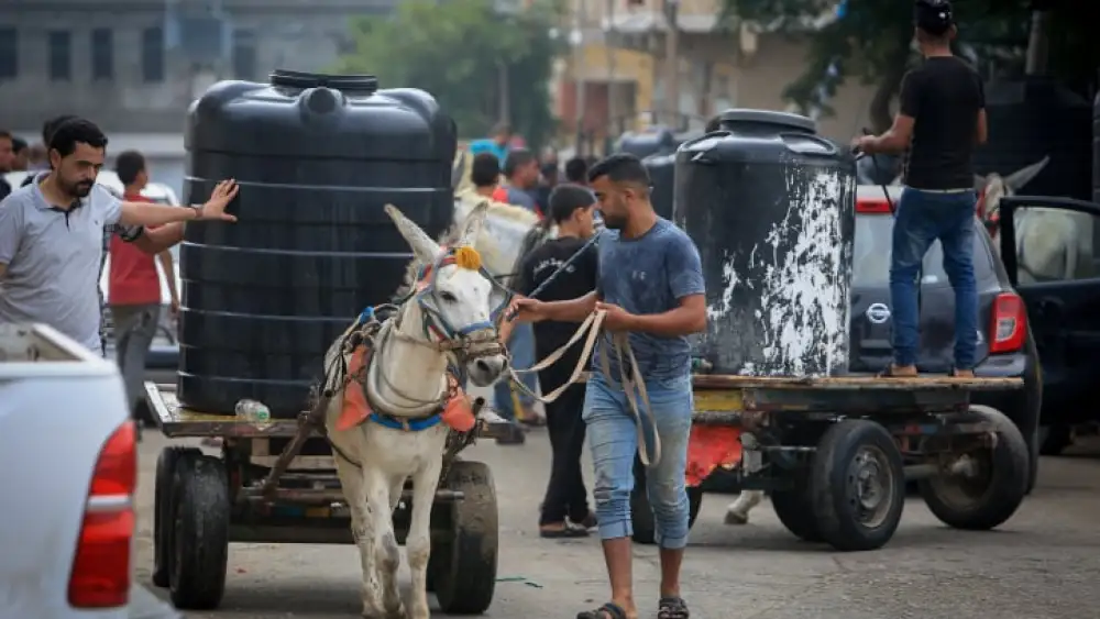 Palestinian civilians wait to collect water in Rafah in the southern Gaza Strip, Oct. 28, 2023. Photo by Abed Rahim Khatib/Flash90.