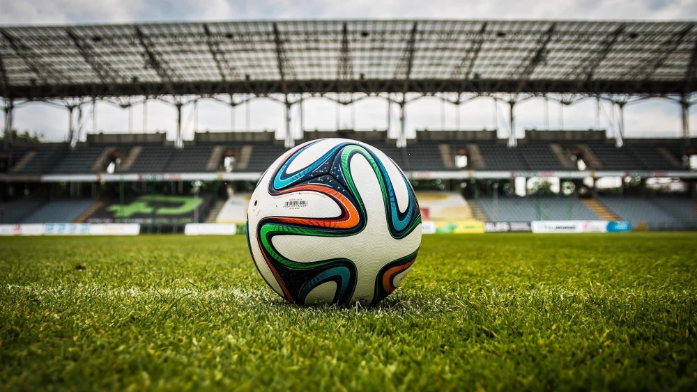 A soccer ball on a field. Credit: jarmoluk/Pixabay.