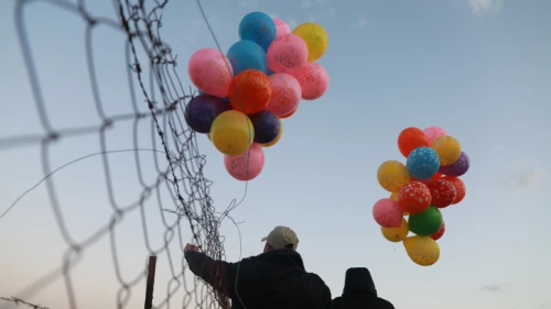 Young Palestinian men prepare an incendiary device to be launched into Israel near the Israel-Gaza border, Jan. 22, 2020. Photo by Ail Ahmed/Flash90.