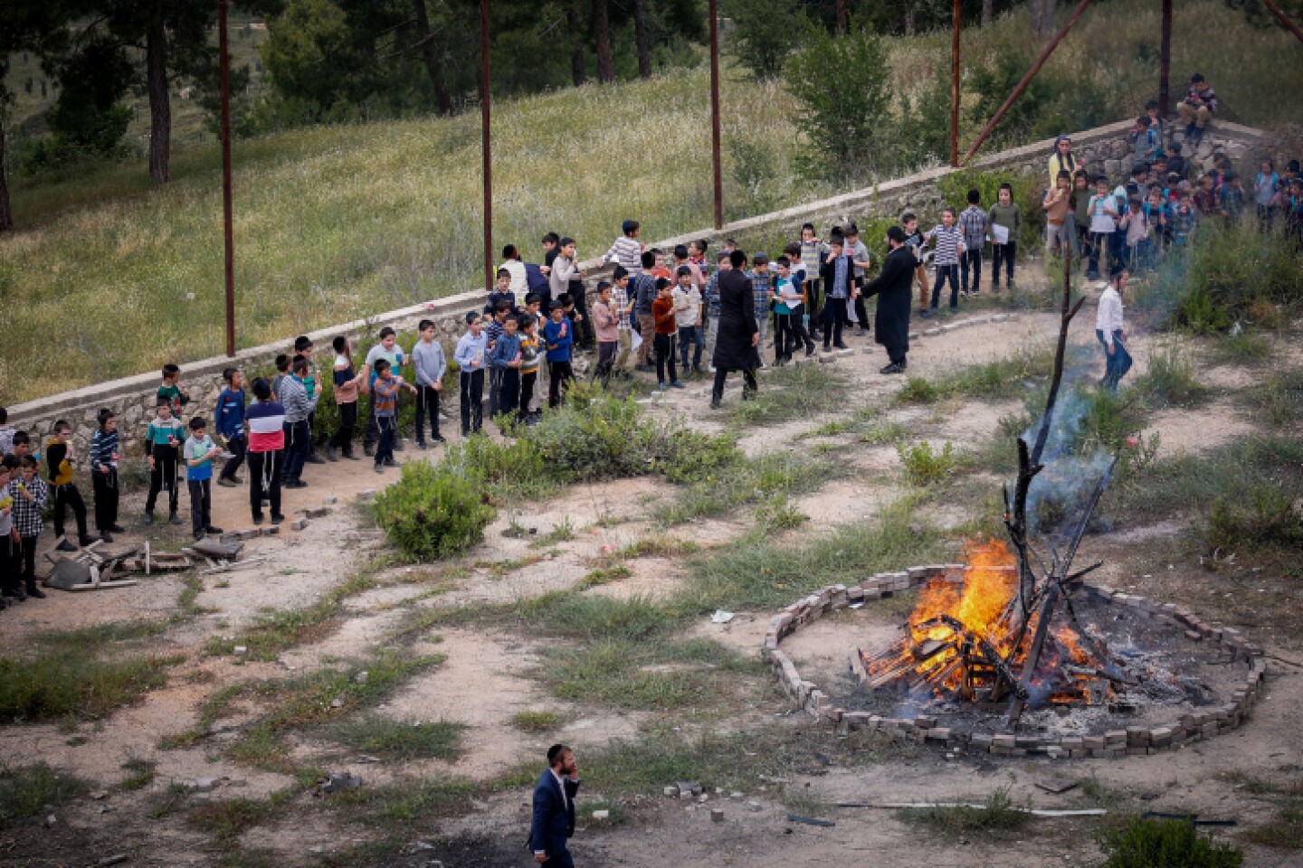 Children and their parents gather around a bonfire ahead of the Jewish holiday of Lag Ba'omer, in the northern Israeli city of Tzfat, May 8, 2023. Photo by Gershon Elinson/Flash90