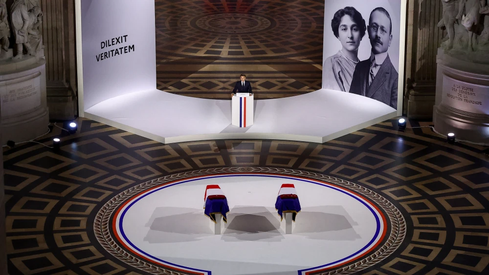 France's President Emmanuel Macron speaks in front of the two flag-draped cenotaphs of the late historian and resistance fighter Marc Bloch and his wife Simonne Bloch during the induction ceremony in Paris on June 23, 2026. Photo by Alice Sacco /POOL/AFP via Getty Images.
