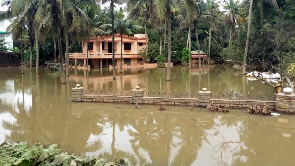 A flooded house in Kerala, India, in August 2018. Photo by Santhosh Varghese/Shutterstock.com.