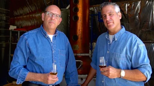 Legends Distillery founders Alan Cohl (left) and Noam Cohen in front of distilling equipment. Credit: Legends Distillery.