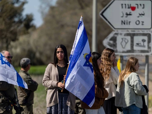 People pay their respects during the funeral procession of late Israeli hostage Oded Lifshitz at the entrance to Kibbutz Nir Oz, Feb. 25, 2025. Photo by Yonatan Sindel/Flash90.