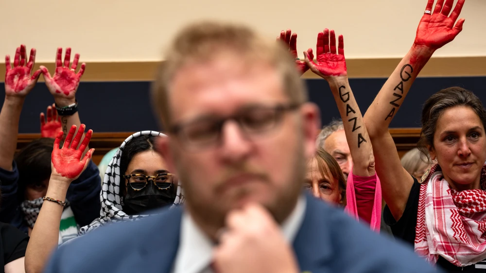 Anti-Israel demonstrators raise their hands as witness Kevin Rachlin, Washington director of the Nexus Leadership Project, listens during a House Judiciary Subcommittee on the Constitution and Limited Government hearing on antisemitism on college campuses at the Rayburn House Office Building on May 15, 2024. Photo by Kent Nishimura/Getty Images.