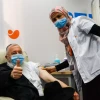 An Israeli receives a COVID-19 vaccine in Jerusalem on Dec. 21, 2020. Photo by Olivier Fitoussi/Flash90.