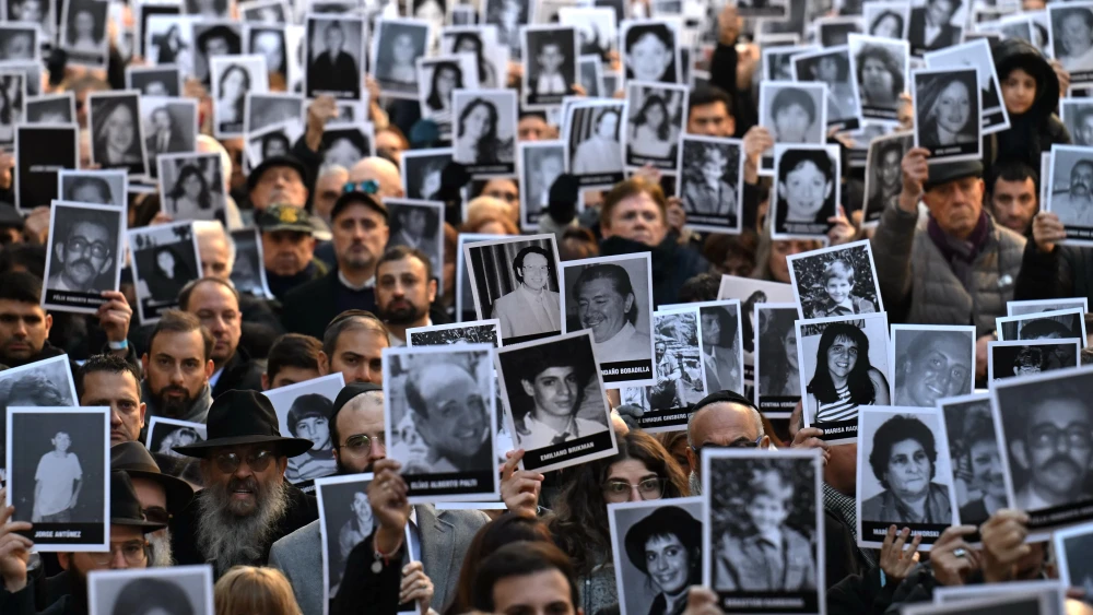People hold pictures of victims during a ceremony to commemorate the 31st anniversary the Mutual Israelite Association of Argentina (AMIA) bombing attack which left 85 dead and more than 300 wounded, in Buenos Aires, July 18, 2025. Photo by Luis Robayo/AFP via Getty Images.