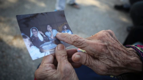 Muftia, the grandmother of Rep. Rashida Tlaib, holds a picture outside her house in the village of Beit Ur Al-Fauqa near Ramallah in Samaria, Aug. 16, 2019. Photo by Flash90.
