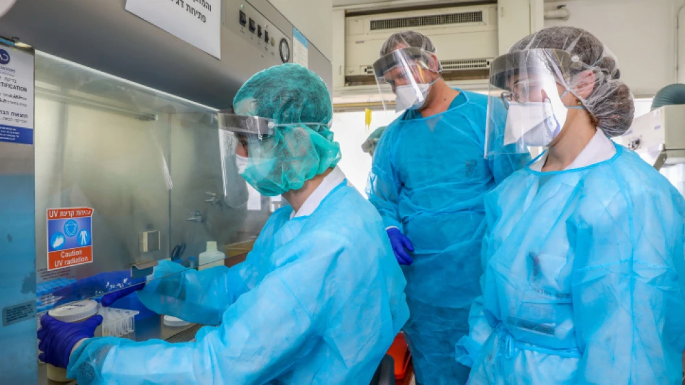 Technicians carry out a diagnostic test for the coronavirus in a lab at the Rambam Health Care Campus in Haifa on March 30, 2020. Photo by Yossi Aloni/Flash90.