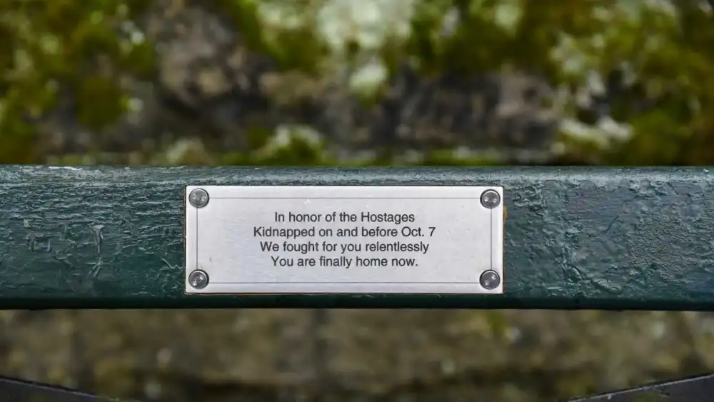 A placard on the “Hostages Bench” in Central Park, New York, dedicated in an event on April 19, 2026, to the hostages abducted by Hamas on Oct. 7, 2023. Credit: Alon Kaplun.