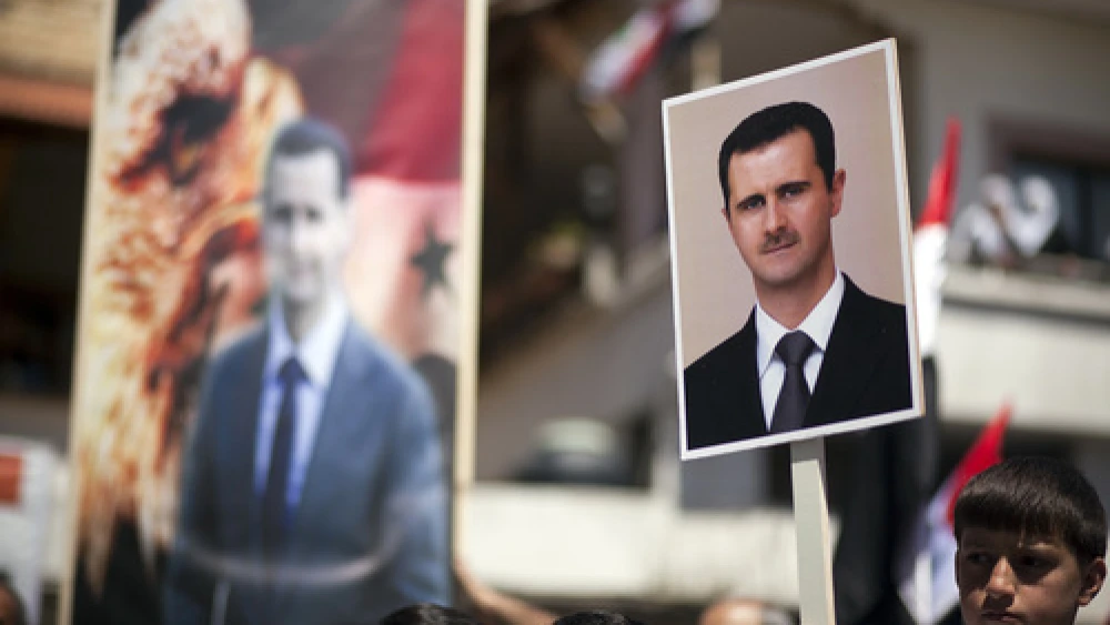 On April 17, 2012, Druze residents of Israel's Golan Heights hold Syrian flags and portraits of Syrian President Bashar Assad during a rally in the Druze village of Majdal Shams to mark the Syrian Independence Day. Credit: Matanya Tausig/Flash90.