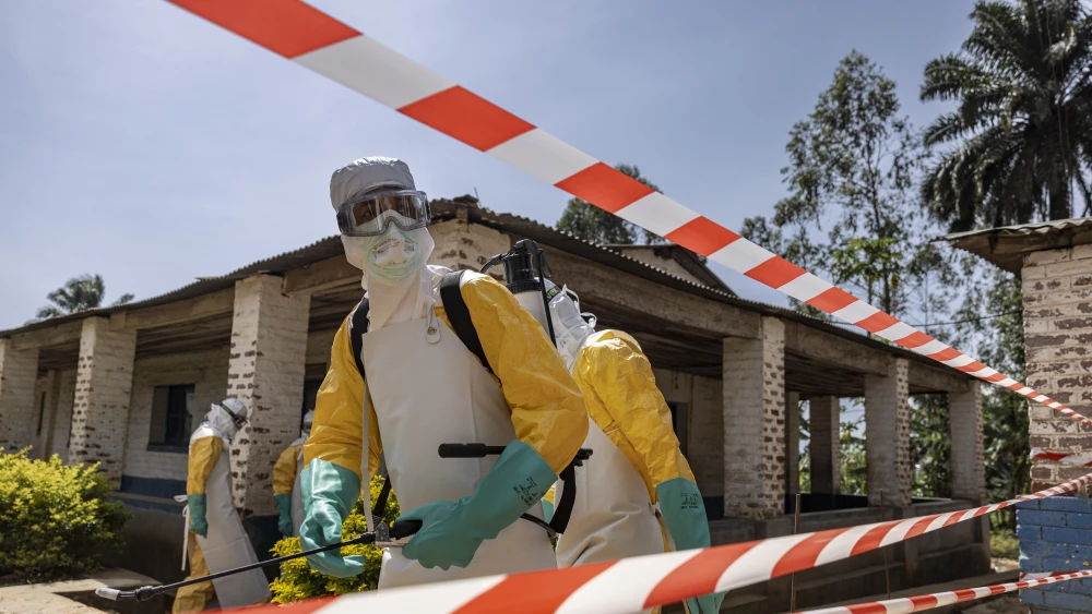 A member of the Médecins Sans Frontières (MSF) Ebola response team disinfects a restricted area outside the General Referral Hospital of Mongbwalu during outbreak preparedness and infection prevention activities in the Democratic Republic of Congo, May 26, 2026. Photo by Michel Lunanga/Getty Images.